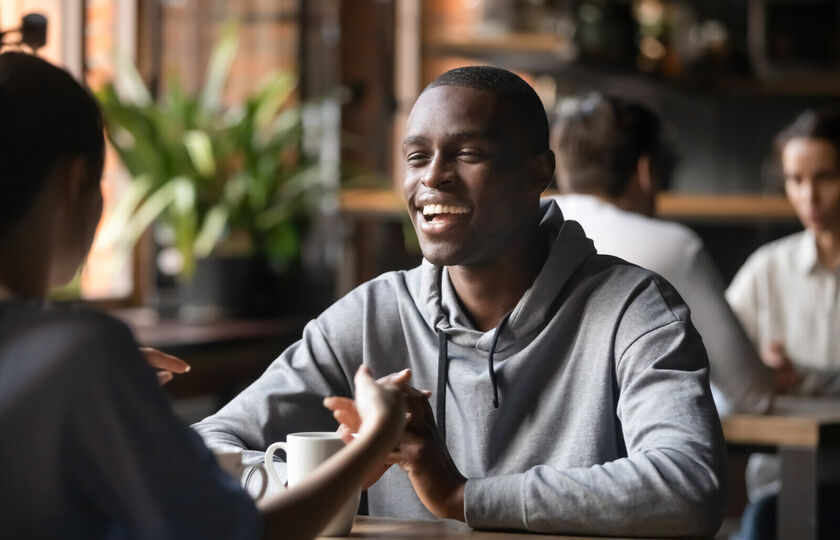 Smiling man on date in coffee shop