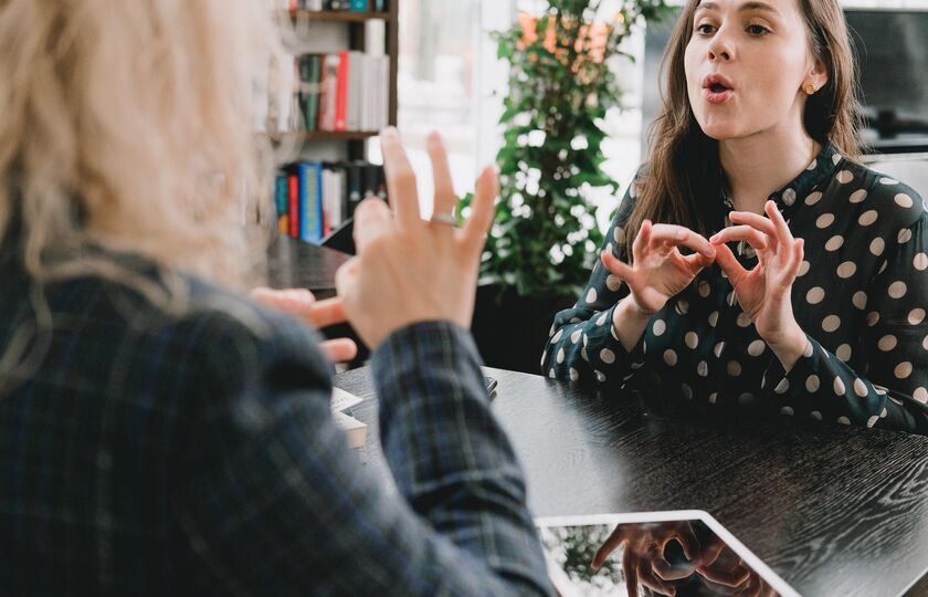 Friends communicating in sign language