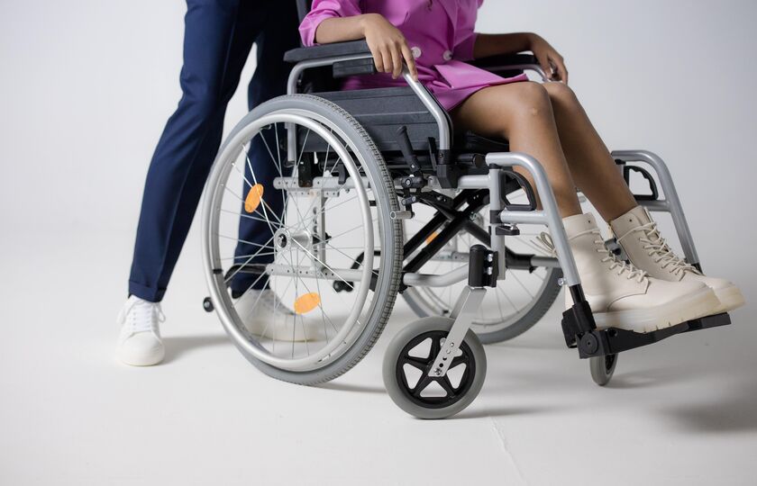 Man pushing woman in wheelchair