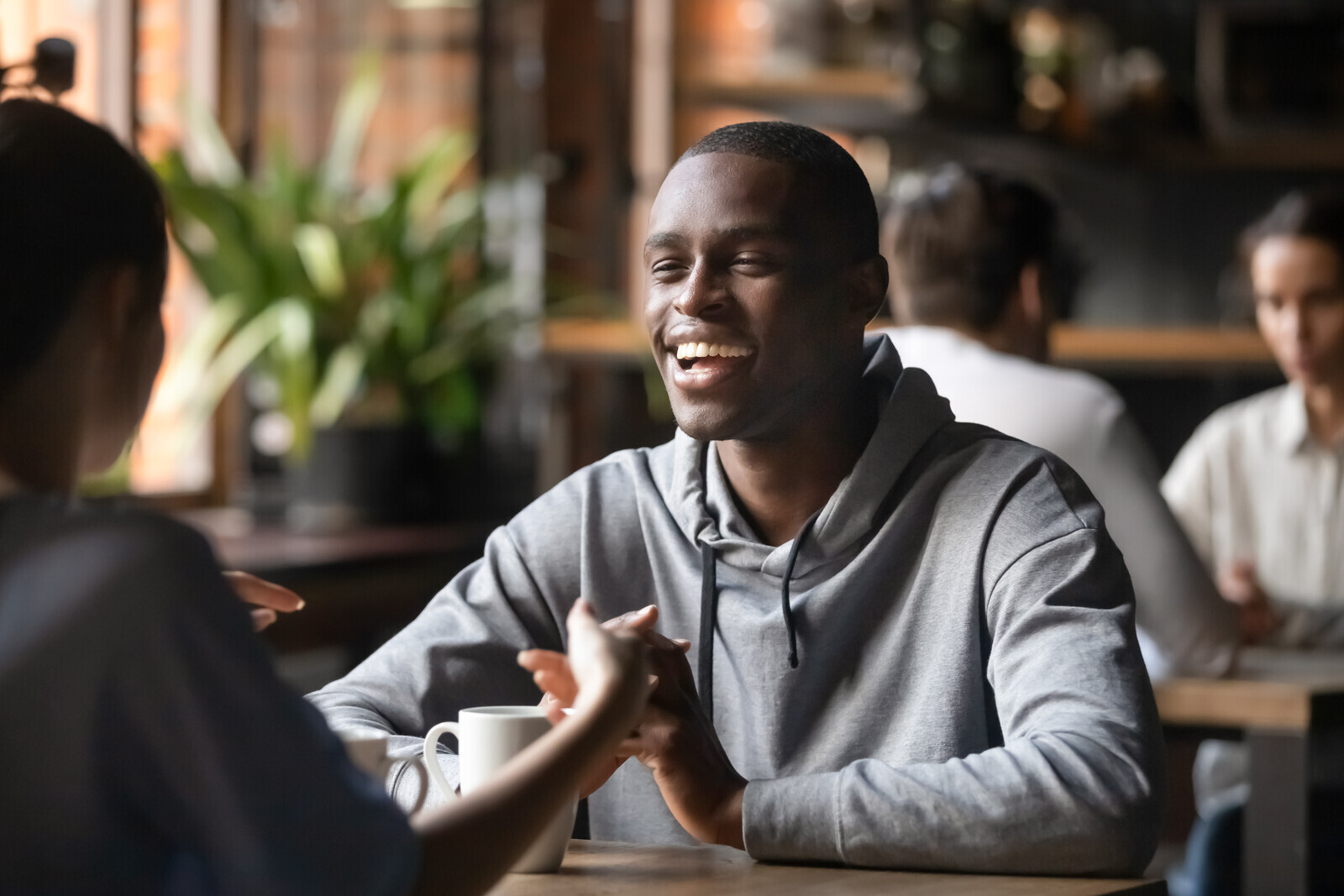 Smiling man on date in coffee shop